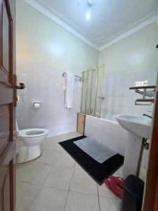 a bathroom with a toilet and a sink at The Terrace Villa in Kampala +54 photos