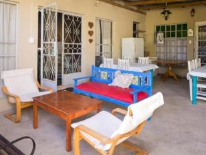 a living room with a couch and a table and chairs at Oude Pastorie in Cradock