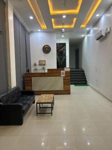 a lobby with a reception desk and a couch at Hotel Elite in Palwal