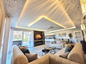 a living room with a couch and a fireplace at Villa Panorama View Brezovica in Brezovica +37 photos