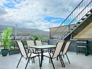 a patio with a table and chairs on a balcony at Villa Panorama View Brezovica in Brezovica