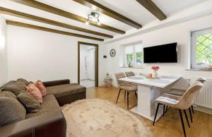 a living room with a couch and a table at Green House in Neunkirchen
