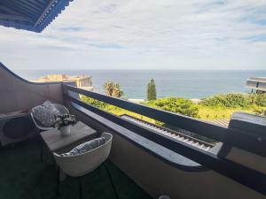 a balcony with a tub and a view of the ocean at Aloe Shore- Whale Watch from Balcony- Stunning in Umdloti