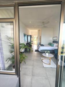a living room with a couch and a table at Aloe Shore- Whale Watch from Balcony- Stunning in Umdloti +13 photos