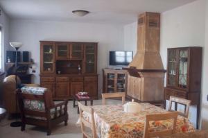 a living room with a table and some wooden furniture at Three Tails House in Capezzano Pianore,