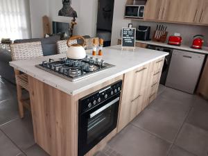 a kitchen with a stove top on a counter at Dung Beetle Bush Villa in Marloth Park +37 photos