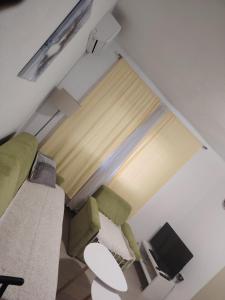a living room with a couch and a window at Apartman Vera in Bileća