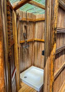 a wooden sauna with a shower in it at Tsara Beach in Nosy Be