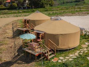 a couple of tents sitting in the grass at Amapolas agri glamping in Camerano
