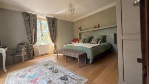 a bedroom with a bed with a bench in it at Les Hauts de Sauliès - Chambre et Table d'Hôtes de charme in Vers +178 photos