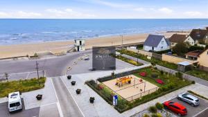 an aerial view of a parking lot next to the beach at Villa La Dorada, Normandy in Ver-sur-Mer