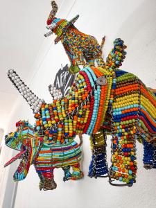 a colorful bead sculpture of an elephant andhtar at Dung Beetle Bush Villa in Marloth Park
