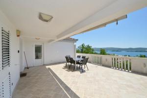 a patio with a table and chairs on a balcony at Zotina Residence in Tivat