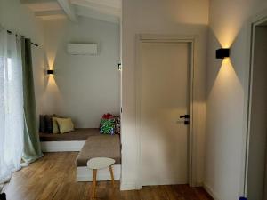 a room with a door with a bed in the background at Agave by Aloe Residence Possidi in Possidi