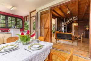 a kitchen and dining room with a table and chairs at écrin de Monpierre in Brion