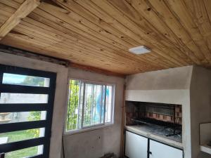a room with a fireplace and a window at El último Cartucho in Tandil