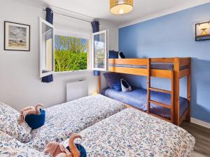 a bedroom with two beds and a bunk bed at Villa La Dorada, Normandy in Ver-sur-Mer