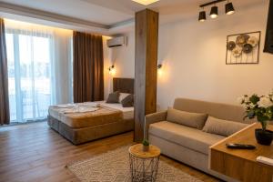 a hotel room with a bed and a couch at Vila Kollari in Ulcinj