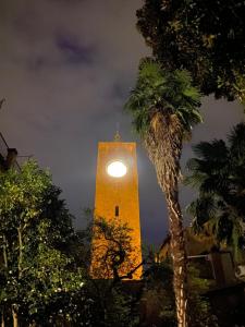a clock tower with a clock on it at night at Hotel Posta - palazzo Guidoni in Orvieto +64 photos