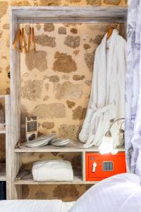 a room with a bed and a shelf with towels at Attiki Hotel in Rhodes Town