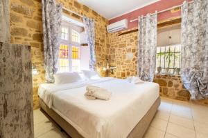a bedroom with a large bed in a room at Attiki Hotel in Rhodes Town