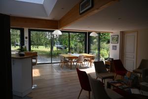 a living room with a table and chairs at La Petite Charnasserie in Angers