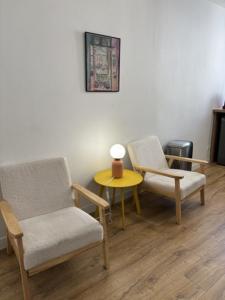 a room with two chairs and a table and a lamp at Cornas in Tournon-sur-Rhône