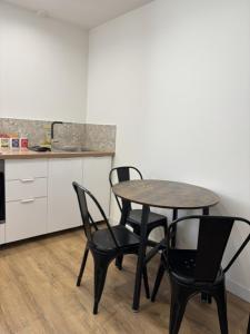 a table and four chairs in a kitchen with a counter at Cornas in Tournon-sur-Rhône