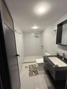 a white bathroom with a sink and a toilet at Wadi Rum Nader Luxury Camp in Wadi Rum +103 photos