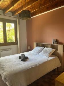 a bedroom with a large bed with a stuffed animal on it at Au p’tit paradis in Fresse