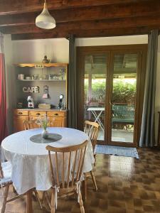 a dining room with a white table and chairs at Au p’tit paradis in Fresse