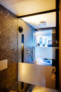 a bathroom with a shower with a glass door at La petite chambre in Bennekom +27 photos