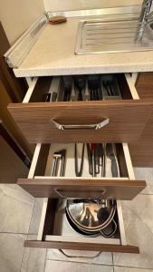a drawer in a kitchen with some utensils at Ehli Keyf Hotel in Istanbul