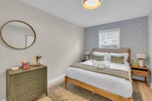 a bedroom with a large bed and a mirror at Prof Cleaned | Linen+Towel | Pet Friendly | Coffee in Seaside Heights