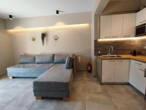 a living room with a couch and a kitchen at SeaEsta Vasiliki 1 in Póndi