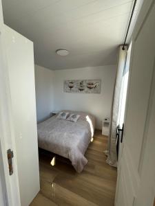 a bedroom with a bed in a small room at Chez Raphaël et Hiba in Nesles