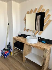 a bathroom with a wooden table with a sink at Chez Raphaël et Hiba in Nesles +8 photos