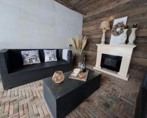 a living room with a couch and a fireplace at Wedderhoeske in Wedde +32 photos