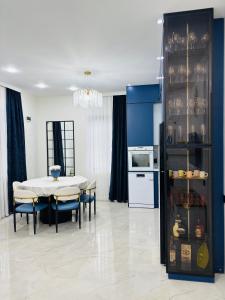 a kitchen and dining room with a table and chairs at Green Villa in Kobuleti