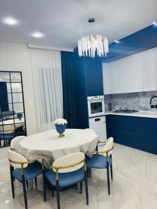 a kitchen with a table and chairs and a kitchen with blue at Green Villa in Kobuleti +19 photos