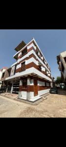 a large building with brown and white at Indigo Inn in Malhour