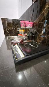 a black counter top with some food on it at Indigo Inn in Malhour