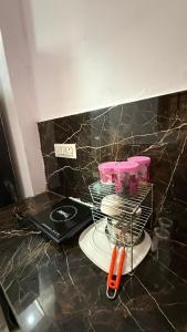 a kitchen counter with a plate and a rack of dishes at Indigo Inn in Malhour +36 photos