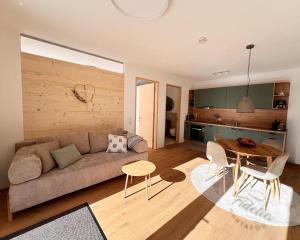 a living room with a couch and a table at Apartment Fidelia in Vandans