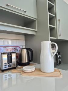 a kitchen counter with a coffee maker and a toaster at CABAÑAS PAMPAS AUSTRALES in Puerto Natales