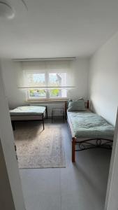 a room with two beds and a window at WorkHome A2 zu 6 in Lünen