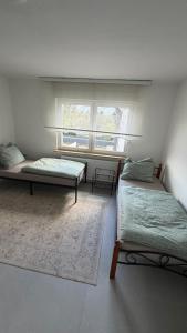 a bedroom with two beds and a window at WorkHome A2 zu 6 in Lünen +3 photos