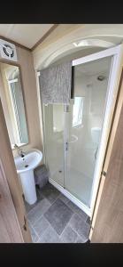 a bathroom with a shower and a sink at Luxury 3 bedroom caravan hobourne Devon bay with hot tub in Goodrington