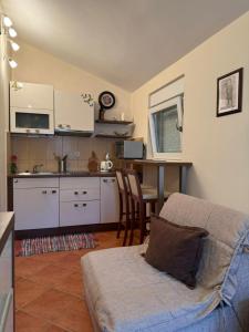 a living room with a couch and a kitchen at Neva in Budva