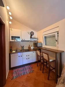 a kitchen with a table and two chairs and a counter at Neva in Budva